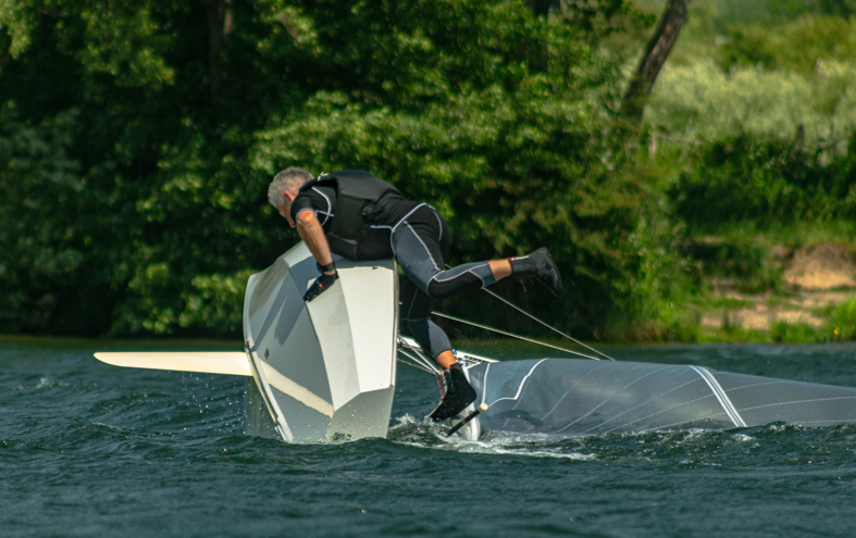 A person in a wet suit on a sailboat AI-generated content may be incorrect.