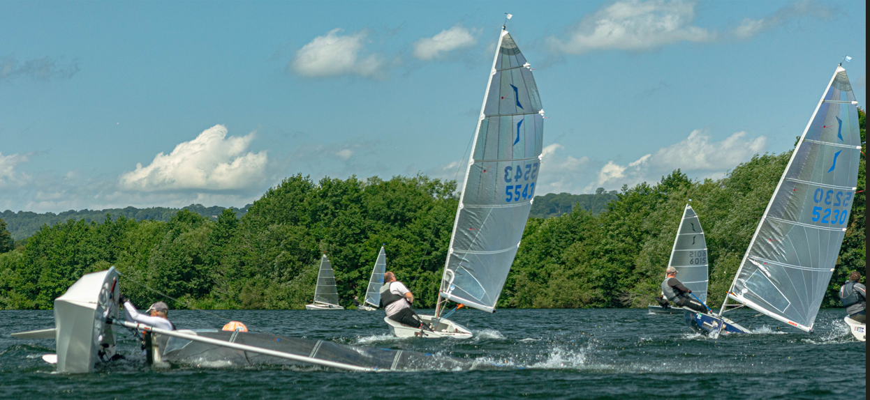 A person on a sailboat on a lake AI-generated content may be incorrect.