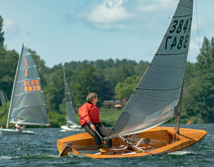 A person sitting on a small sailboat AI-generated content may be incorrect.