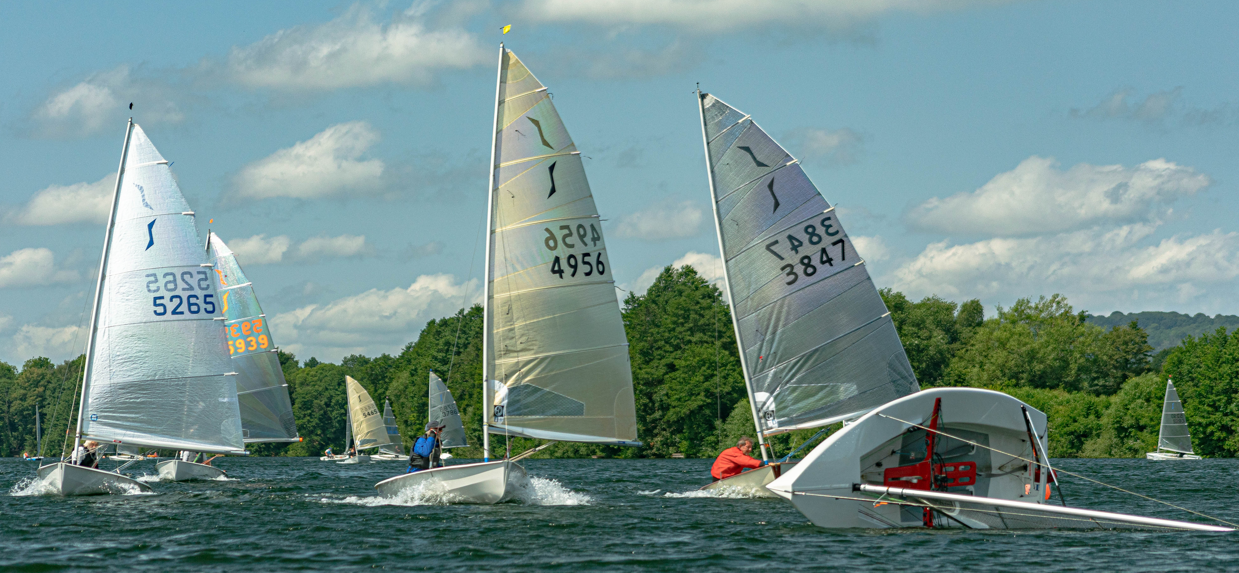 Several sailboats on a lake AI-generated content may be incorrect.