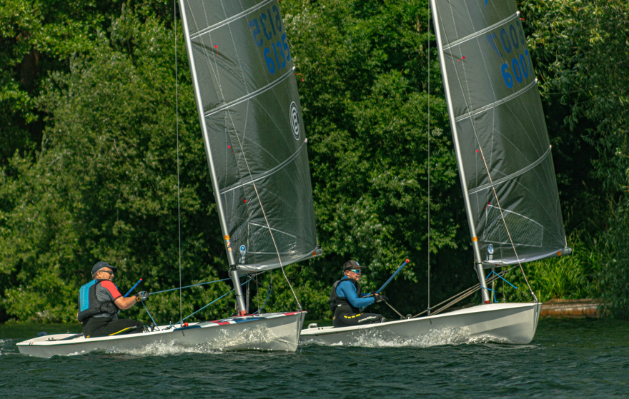Two people sailing on a lake AI-generated content may be incorrect.